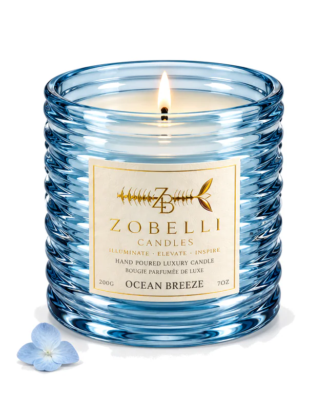 Ocean Breeze Zobelli candle in blue ripple glass with a printed gold paper label on a white studio background
